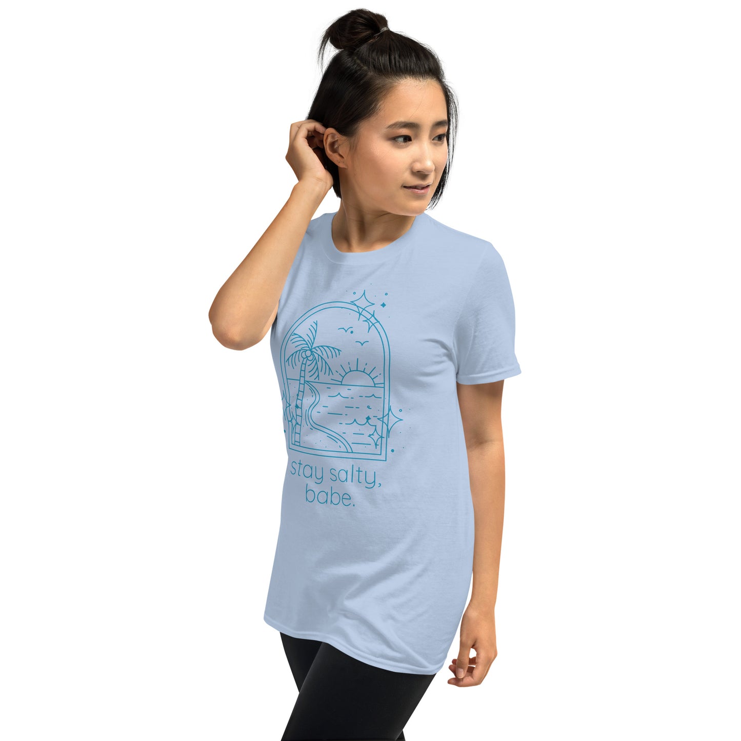 Woman wearing light blue “Stay Salty, Babe” beach t-shirt