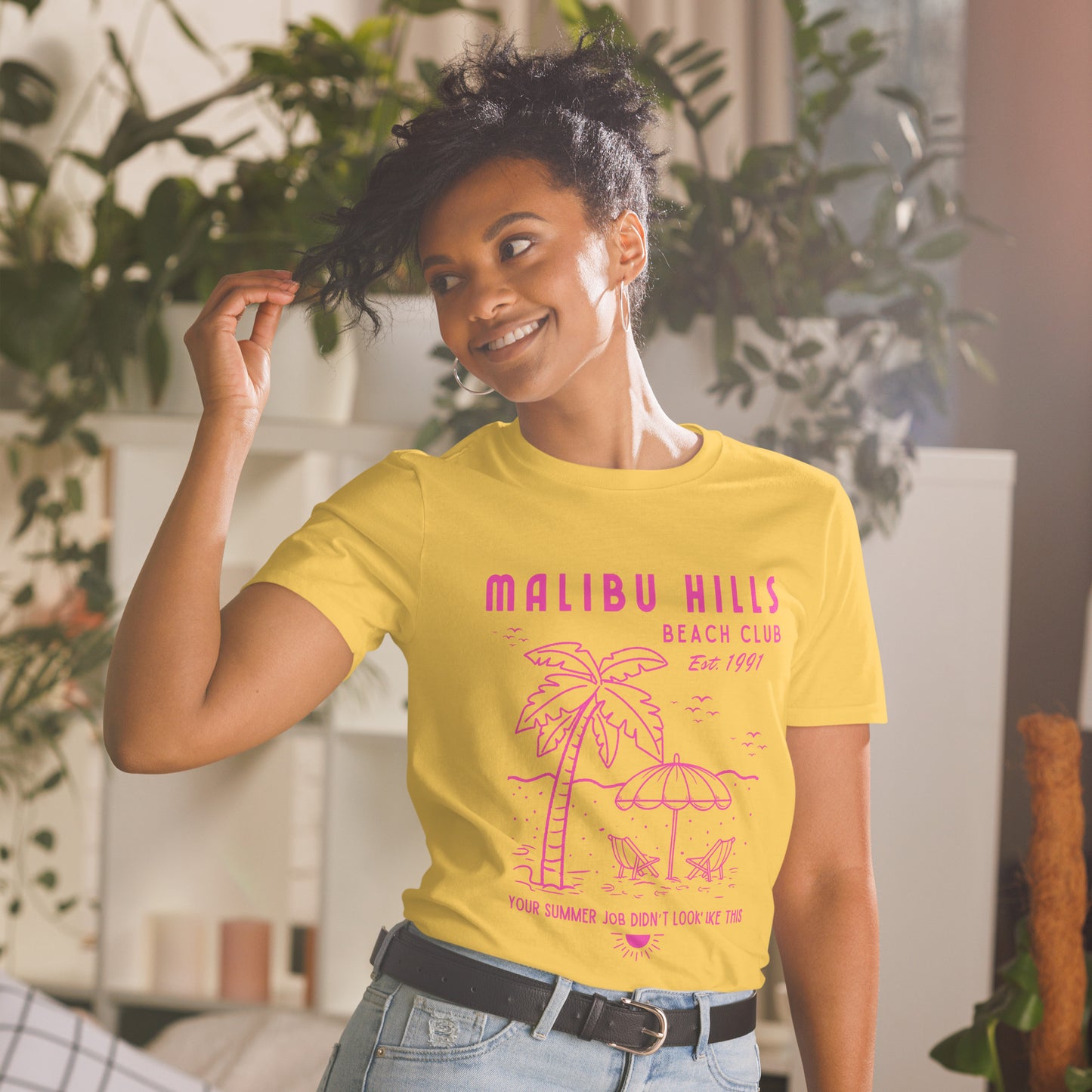 Model wearing Malibu Hills Beach Club retro 90s summer tee in daisy yellow with hot pink graphic, casual fit