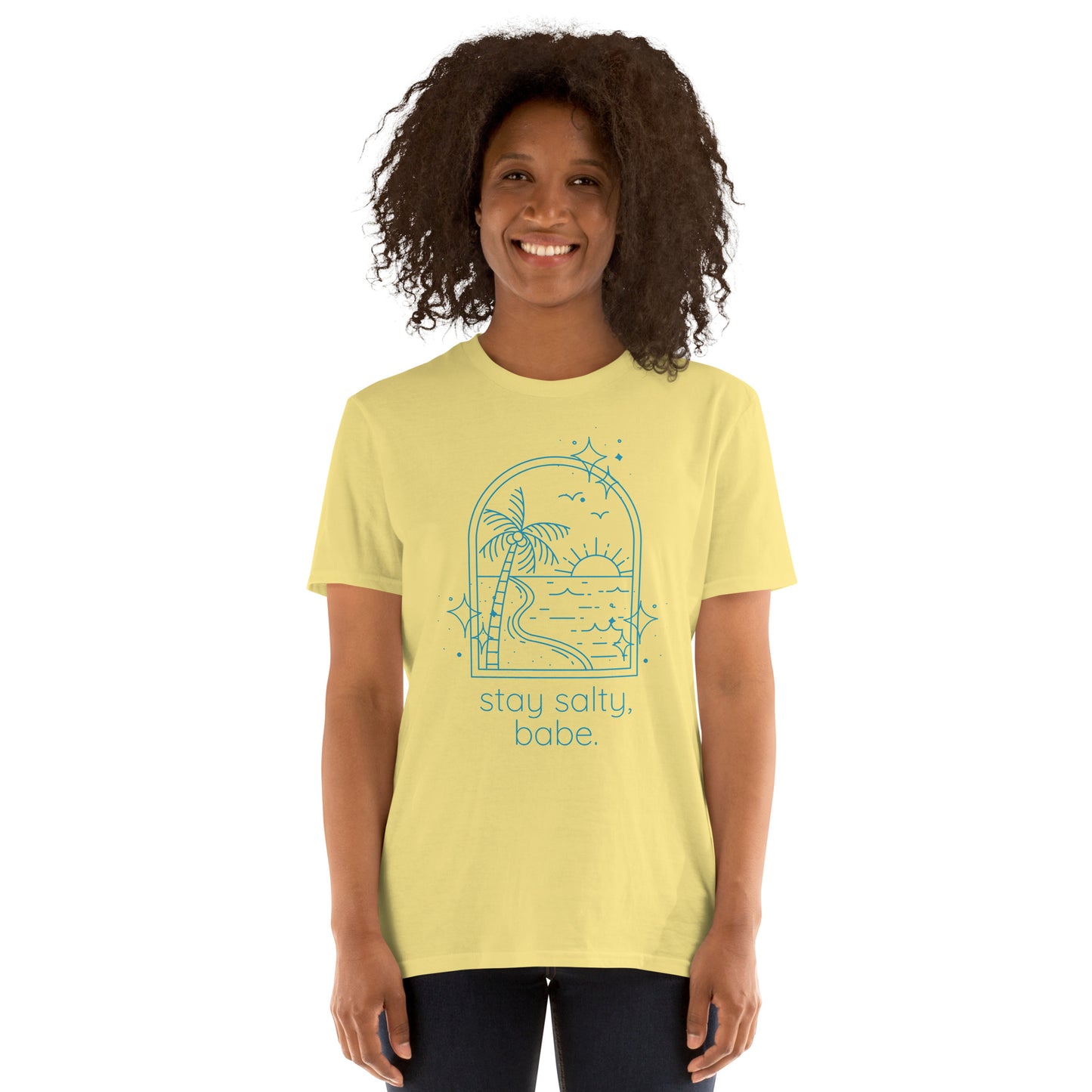 Woman in in soft yellow “Stay Salty, Babe” tee with bright blue image and text