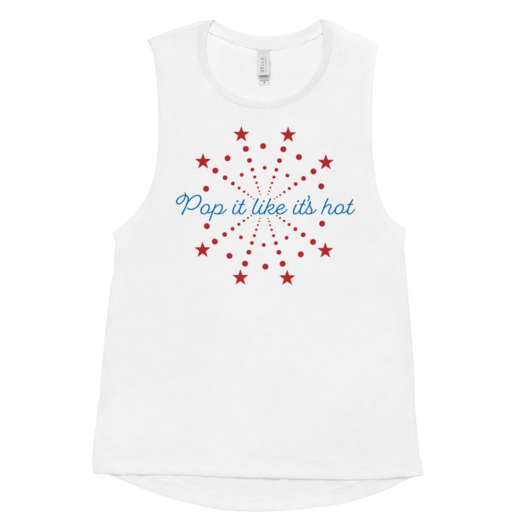 Flat lay of white women’s 4th of July muscle tank with “Pop It Like It’s Hot” red and blue firework graphic