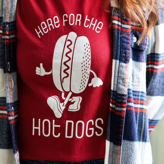 Close-up of Here for the Hot Dogs Tee shirt in red with a plaid flannel for Fall
