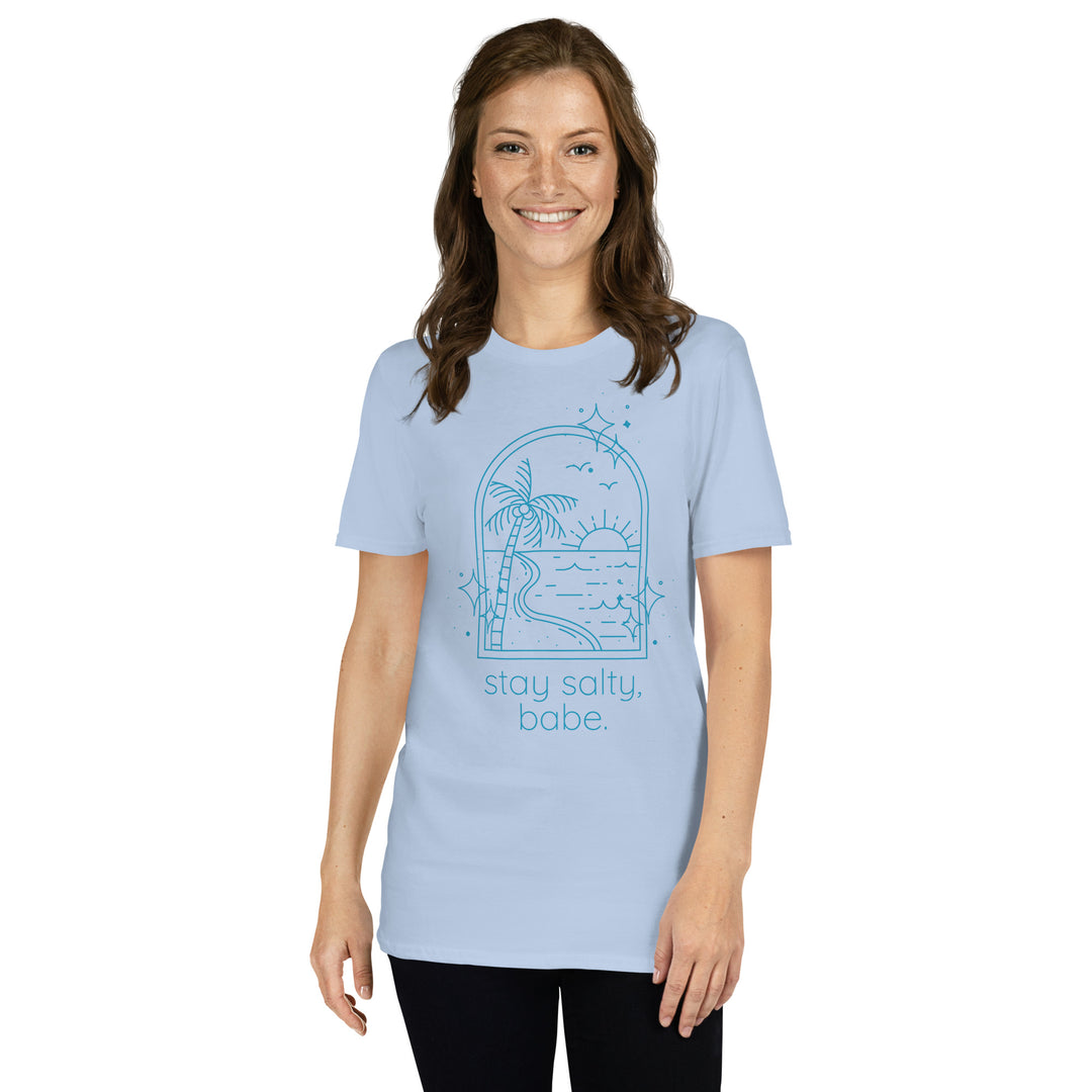 Woman wearing light blue “Stay Salty, Babe” beach graphic tee with relaxed fit