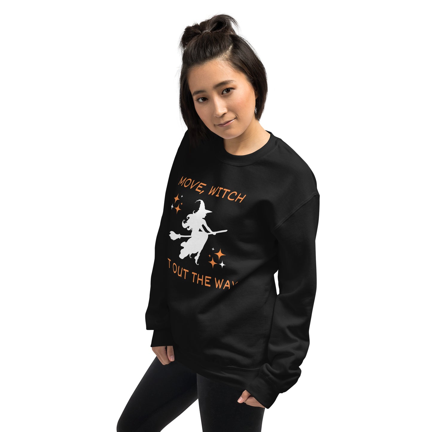 Woman wears black Halloween sweatshirt with the white silhouette of a witch on a broomstick. The shirt says "Move, Witch Get out the way".