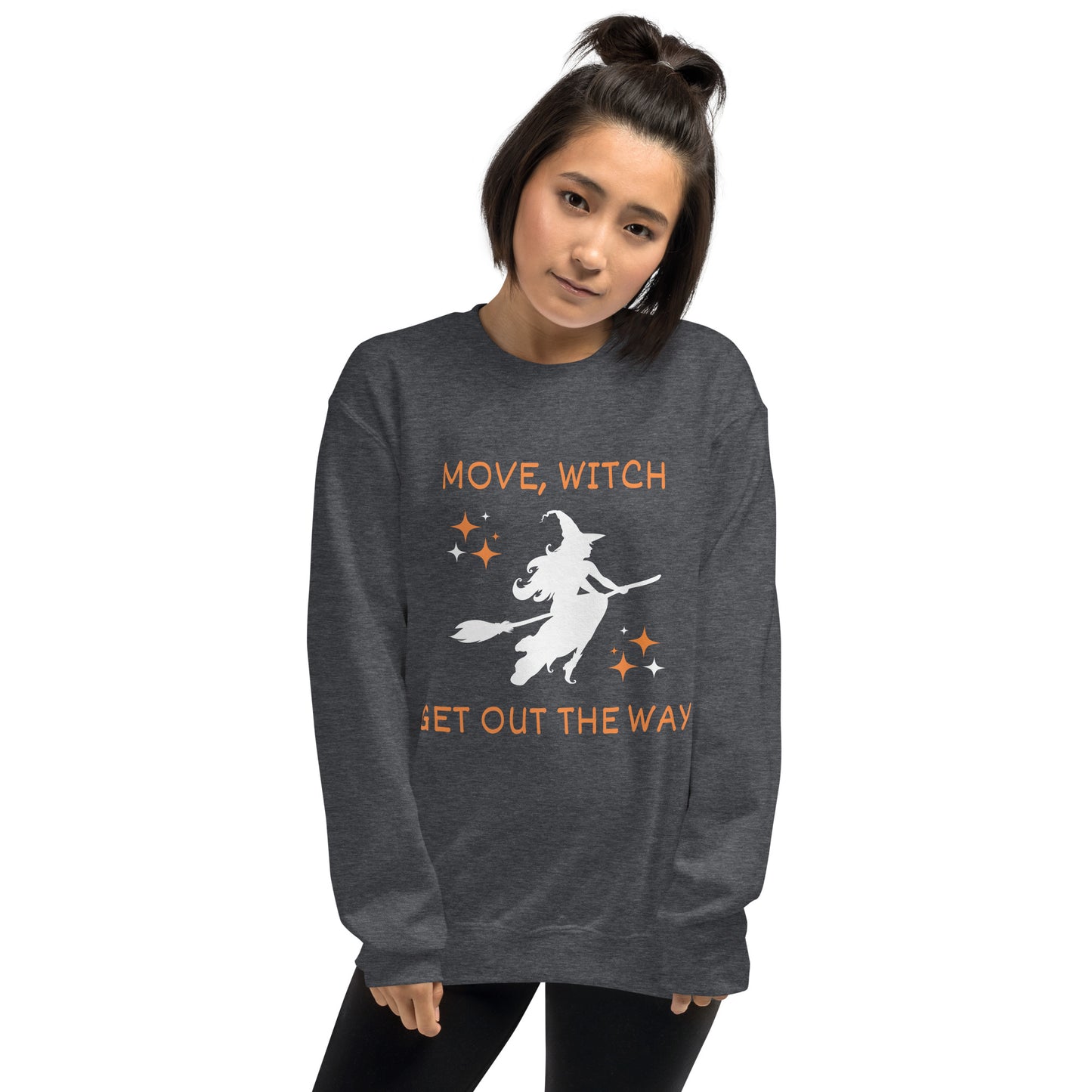 Woman wears gray Halloween sweatshirt with the white silhouette of a witch on a broomstick. The shirt says "Move, Witch Get out the way".