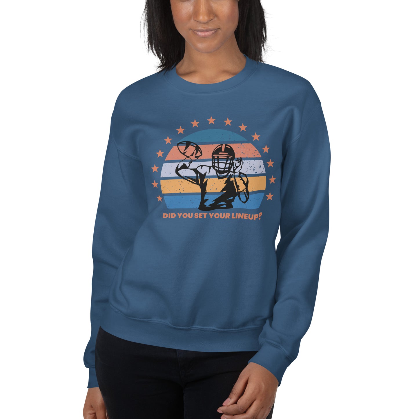 Young woman wears a fantasy football sweatshirt that reads "Did you set your line up?" The sweatshirt has a silhouette of a quarterback about the throw a football with a distressed backdrop of yellow, blues, and light pink and a star border.