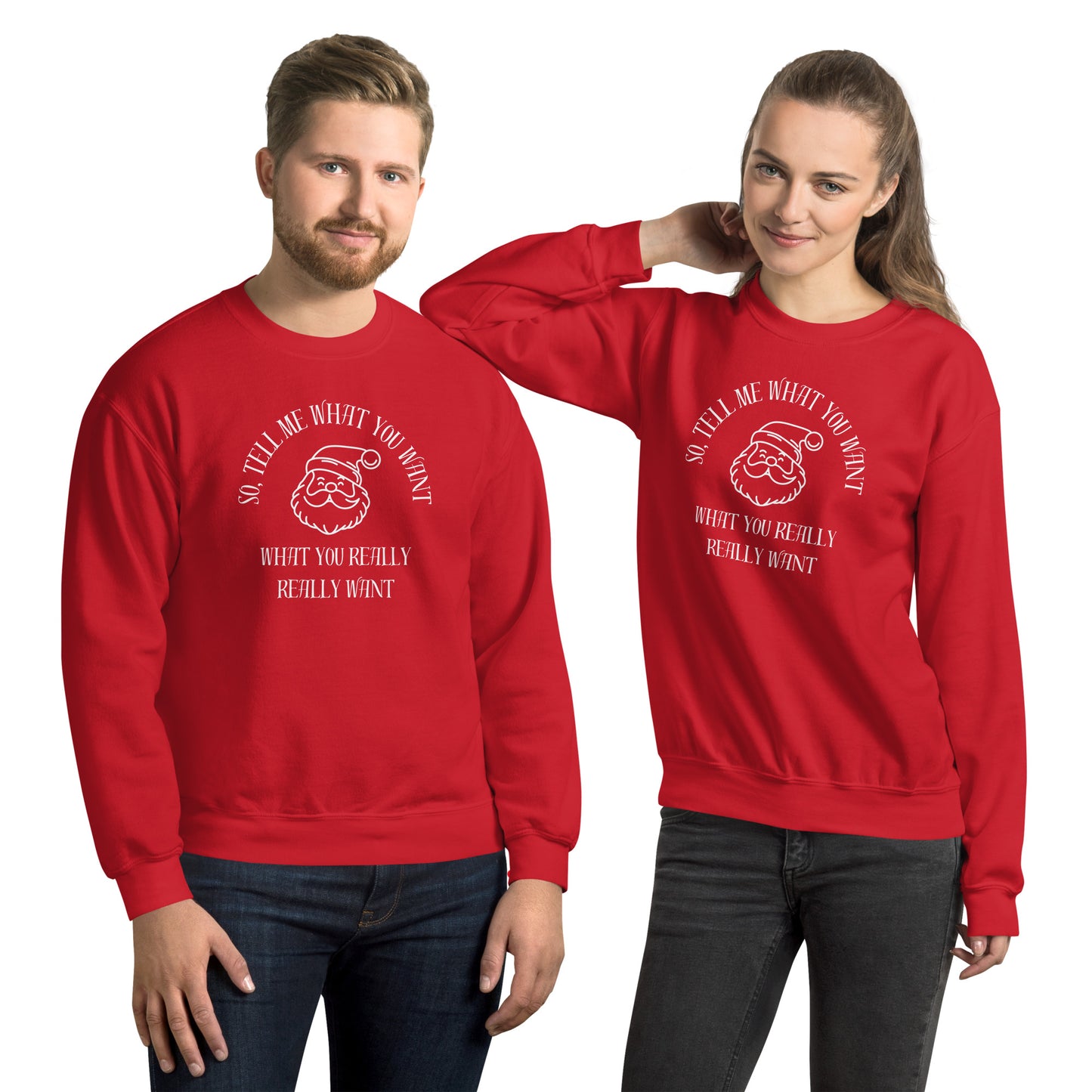 Couple wears matching red crewneck sweatshirts featuring Santa's face and text that reads "So Tell Me What You Want What You Really Really Want," playfully referencing the Spice Girls song while incorporating holiday humor.