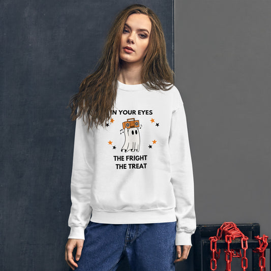 Woman with long brown hair wears a Halloween sweatshirt featuring a ghost holding an orange boombox overhead, Say Anything style. The shirt reads "In your eyes - The Fright, The Treat."