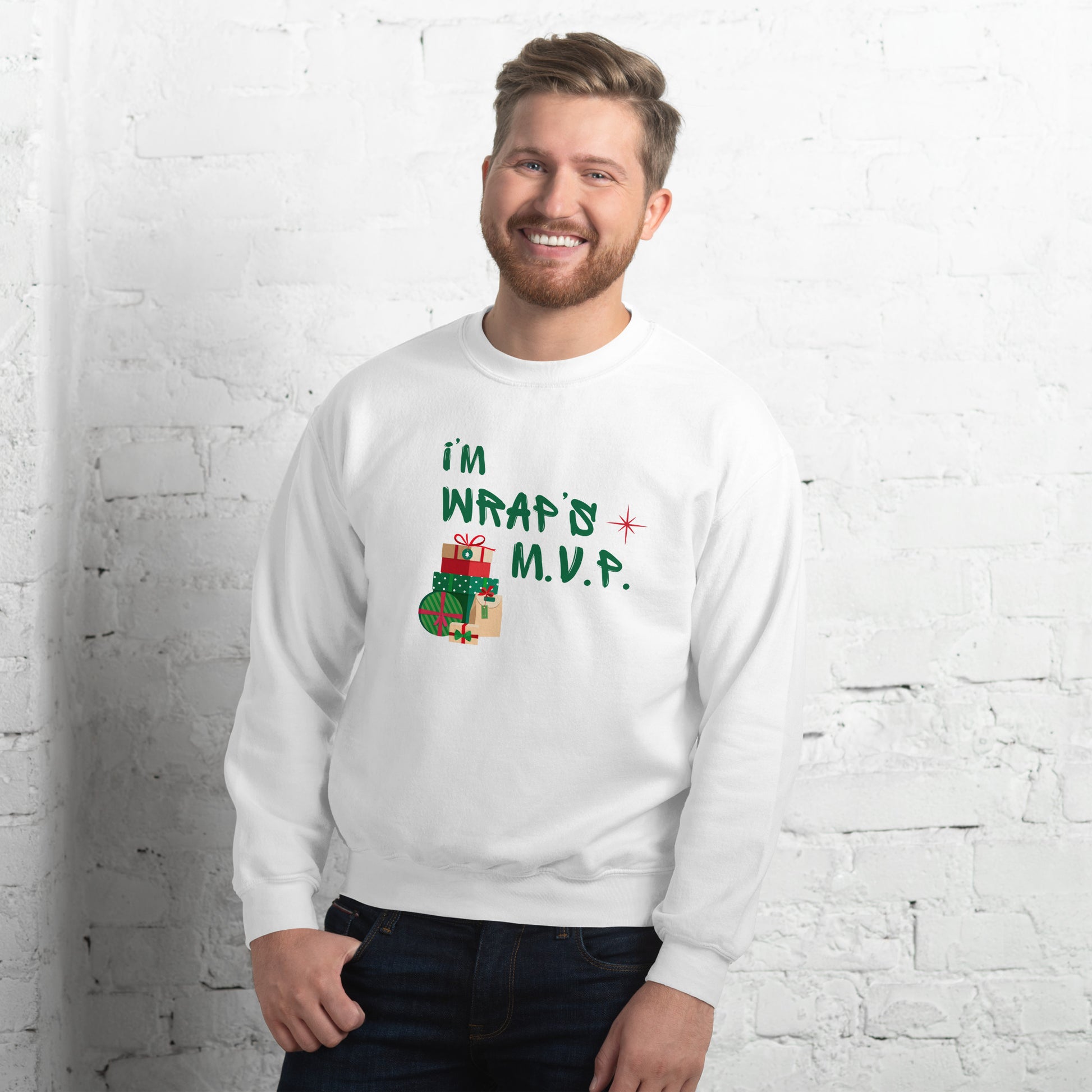 Man wears cozy white crewneck sweatshirt with text reading 'I'M WRAPs M.V.P.' and festive gift icons. A humorous Christmas play on words for holiday gift-wrapping enthusiasts.