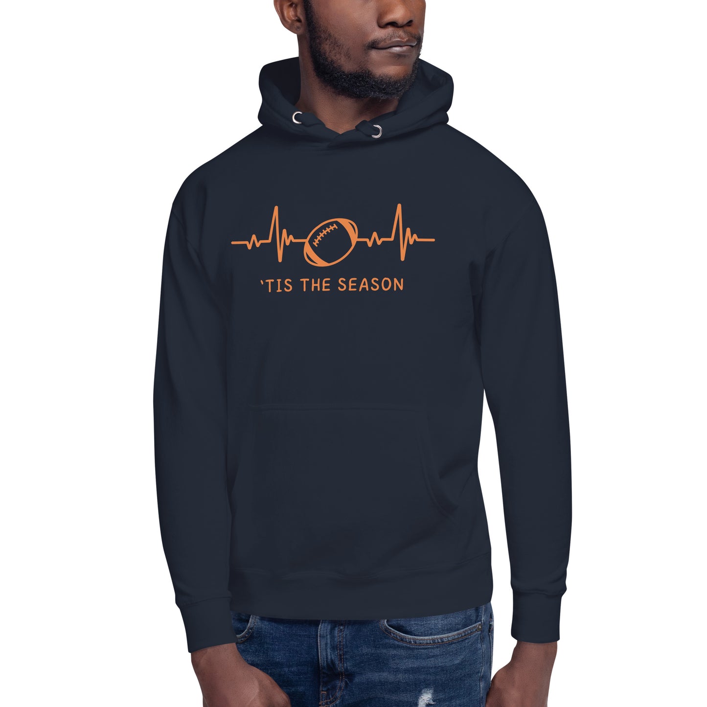 Bearded man wears and orange and blue football hoodie with Chicago Bears colors.  The navy blue sweatshirt showcases a bright orange heart monitor line with a football right in the center. The shirt reads 'TIS THE SEASON underneath.