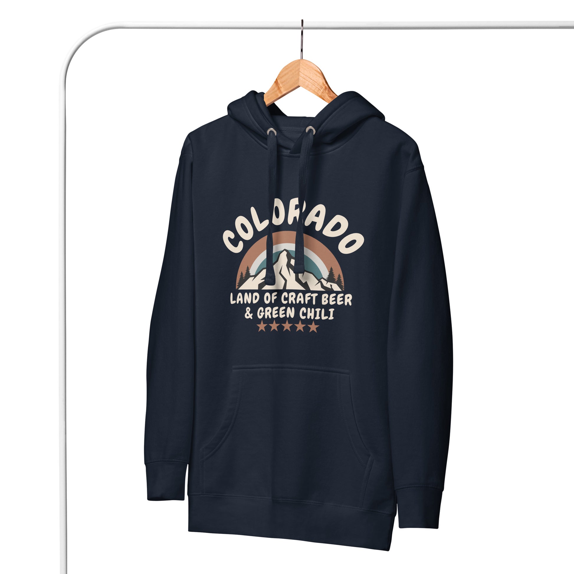 A navy blue Colorado hoodie hangs on a wooden hanger against a white background. The comfy hoodie features a retro mountain design and references craft beer and green chili.