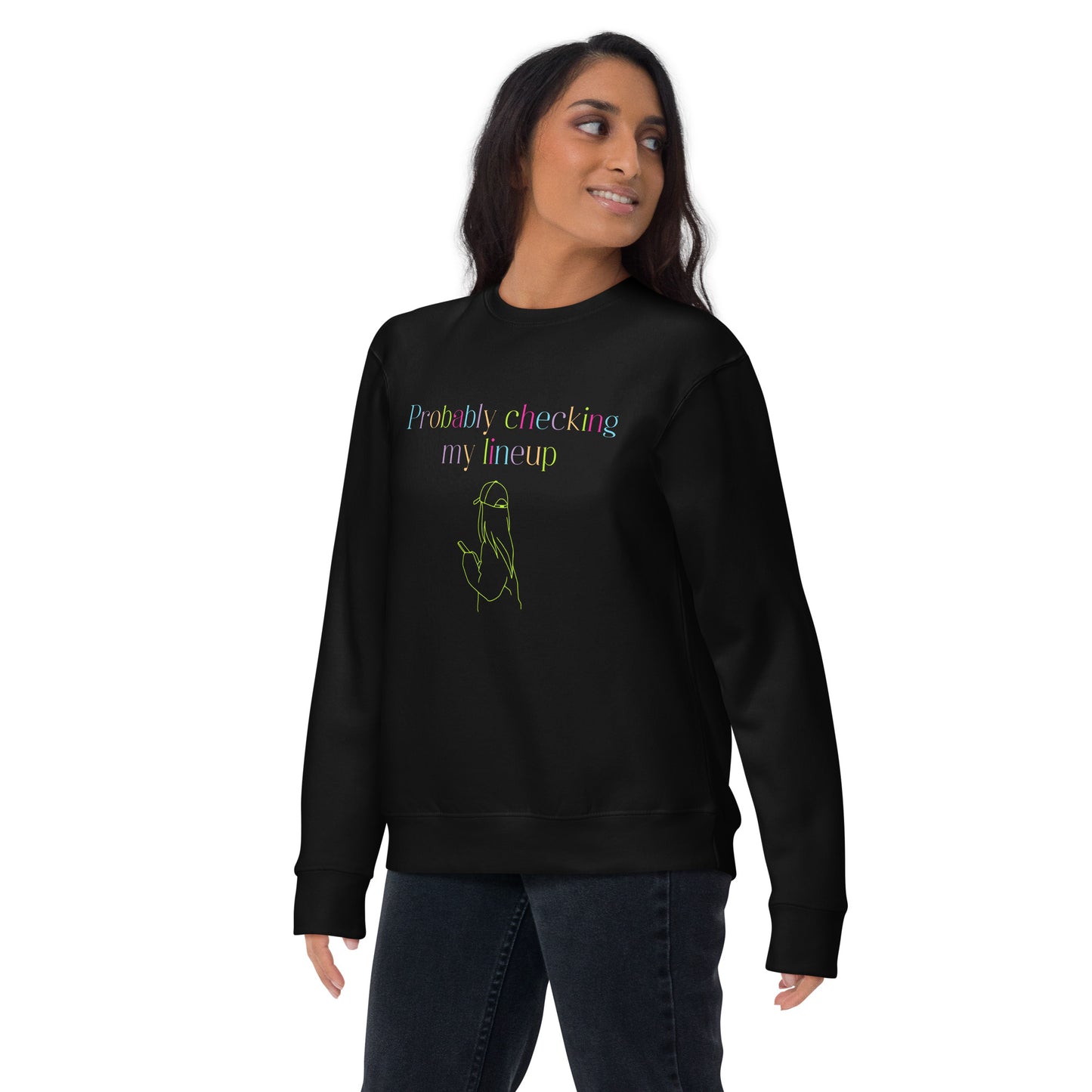 Woman wears a fantasy football sweatshirt that says "probably checking my lineup" in multi colored fluorescent letters. It features line art of a woman in a baseball cap looking at your phone.