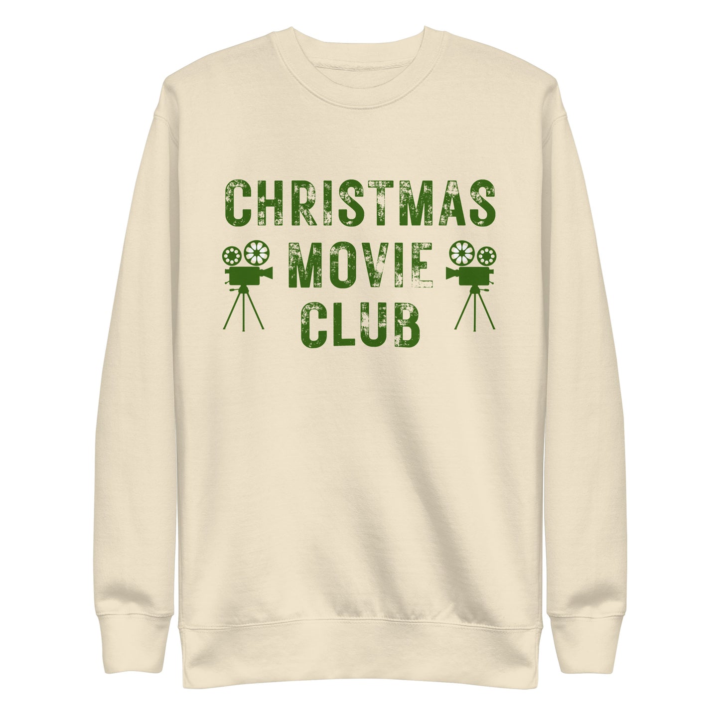 Cream colored crewneck sweatshirt with distressed green text reading 'CHRISTMAS MOVIE CLUB', decorated with retro movie camera icons. Perfect for holiday movie marathons.