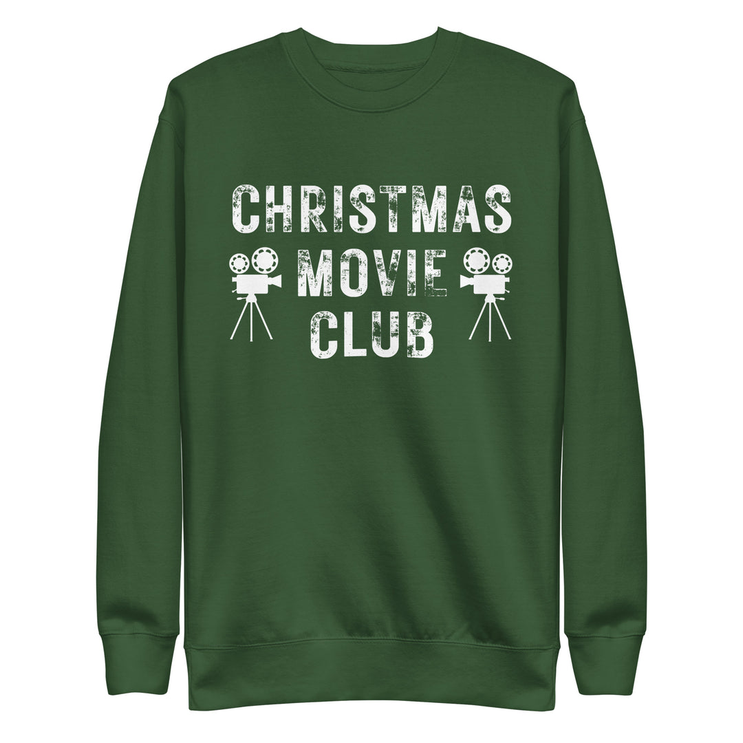 Forest green crewneck sweatshirt with distressed white text reading 'CHRISTMAS MOVIE CLUB', decorated with retro movie camera icons. Perfect for holiday movie marathons.