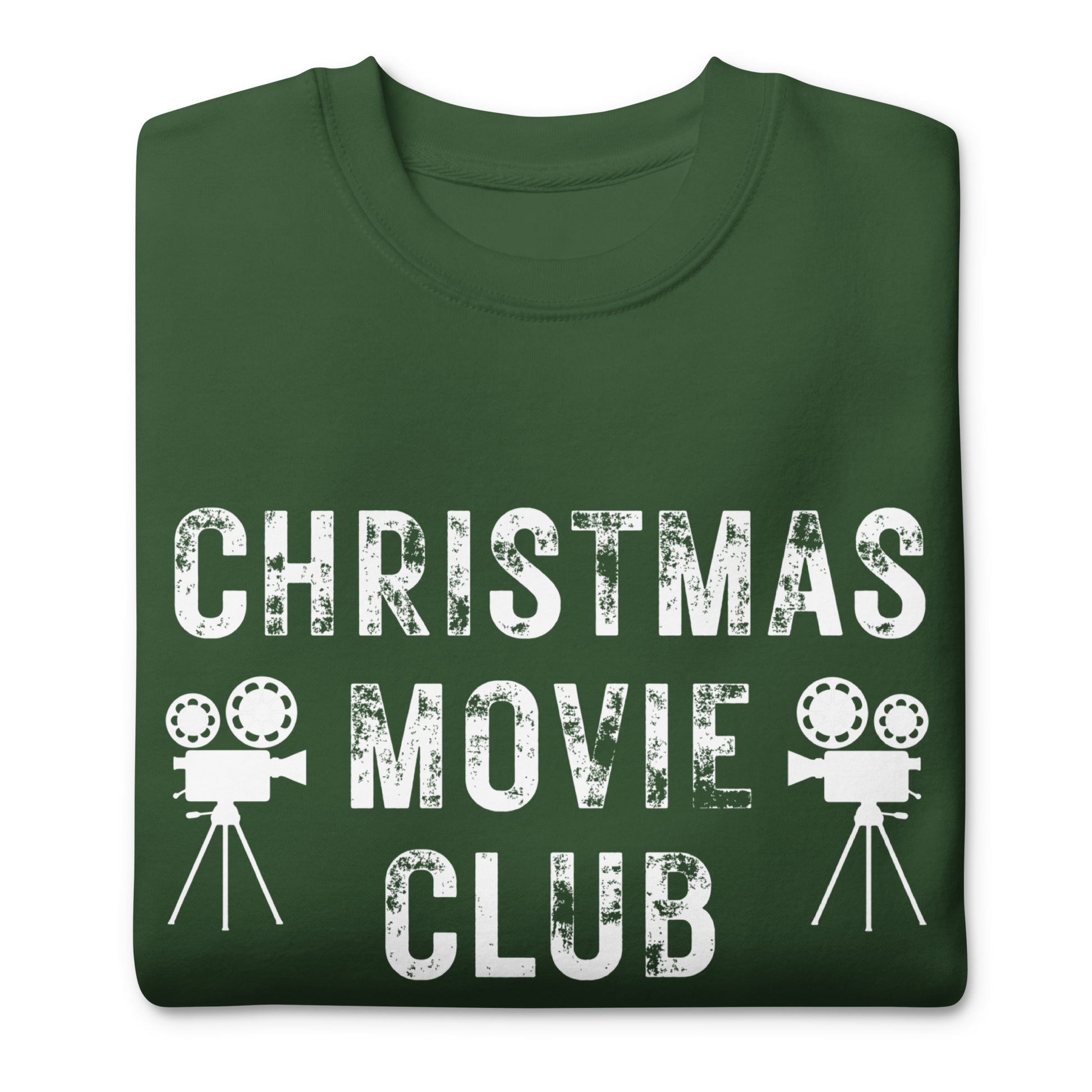 Forest green crewneck sweatshirt with distressed white text reading 'CHRISTMAS MOVIE CLUB', decorated with retro movie camera icons. Perfect for holiday movie marathons.