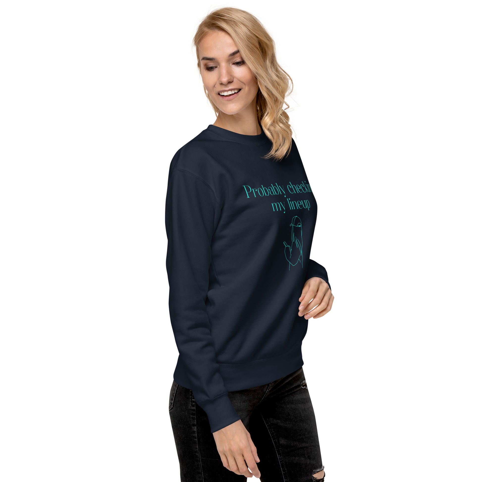 Woman wears a fantasy football sweatshirt that says "probably checking my lineup" It features line art of a woman in a baseball cap looking at your phone.