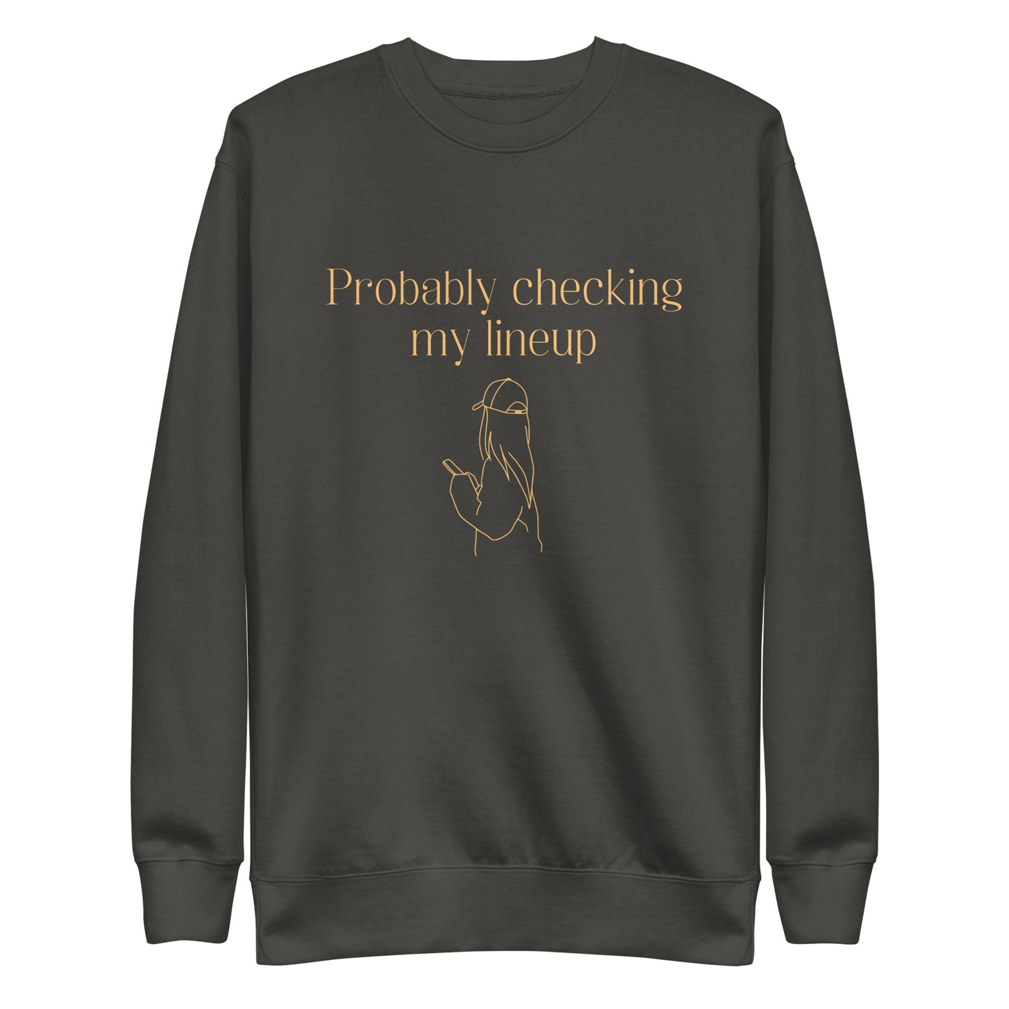 Gray crewneck sweatshirt with tangerine colored line art and text shows a woman in a baseball cap checking her phone. The shirt reads "PROBABLY CHECKING MY LINEUP", a nod to women fantasy football managers.