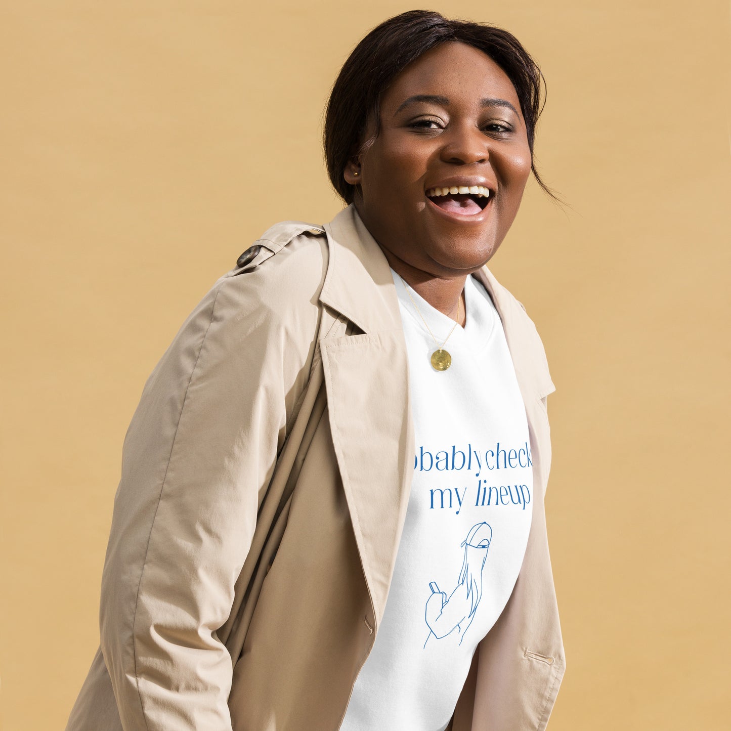 Smiling woman wears a fantasy football sweatshirt that says "probably checking my lineup" It features line art of a woman in a baseball cap looking at your phone.