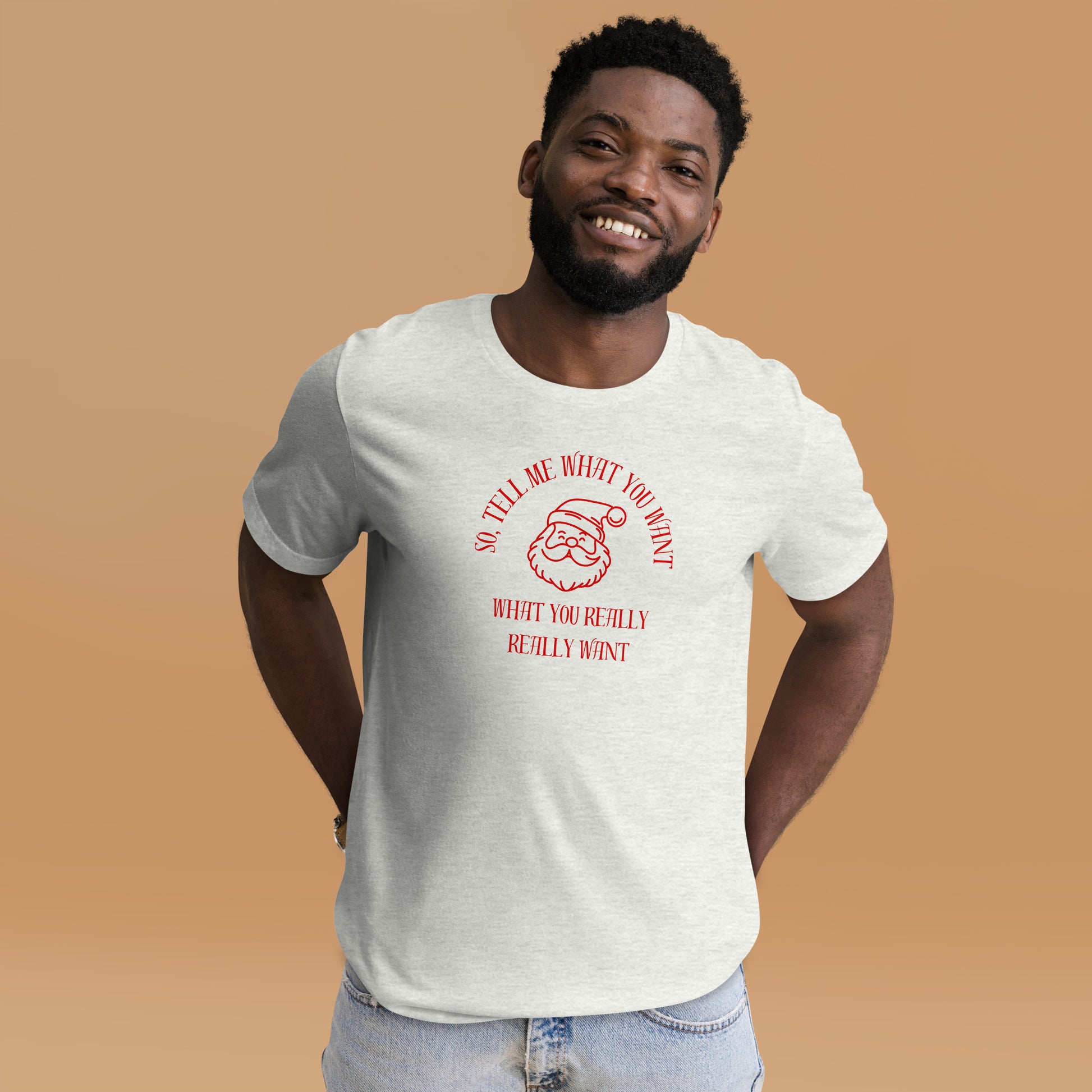 Smiling man wears festive unisex tee shirt featuring Santa's face and the text "So Tell Me What You Want What You Really Really Want"