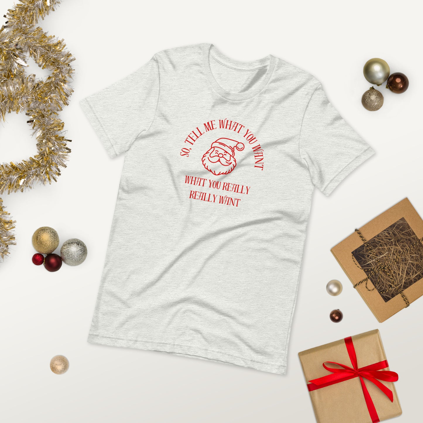 Festive unisex tee shirt featuring Santa's face and the text "So Tell Me What You Want What You Really Really Want"