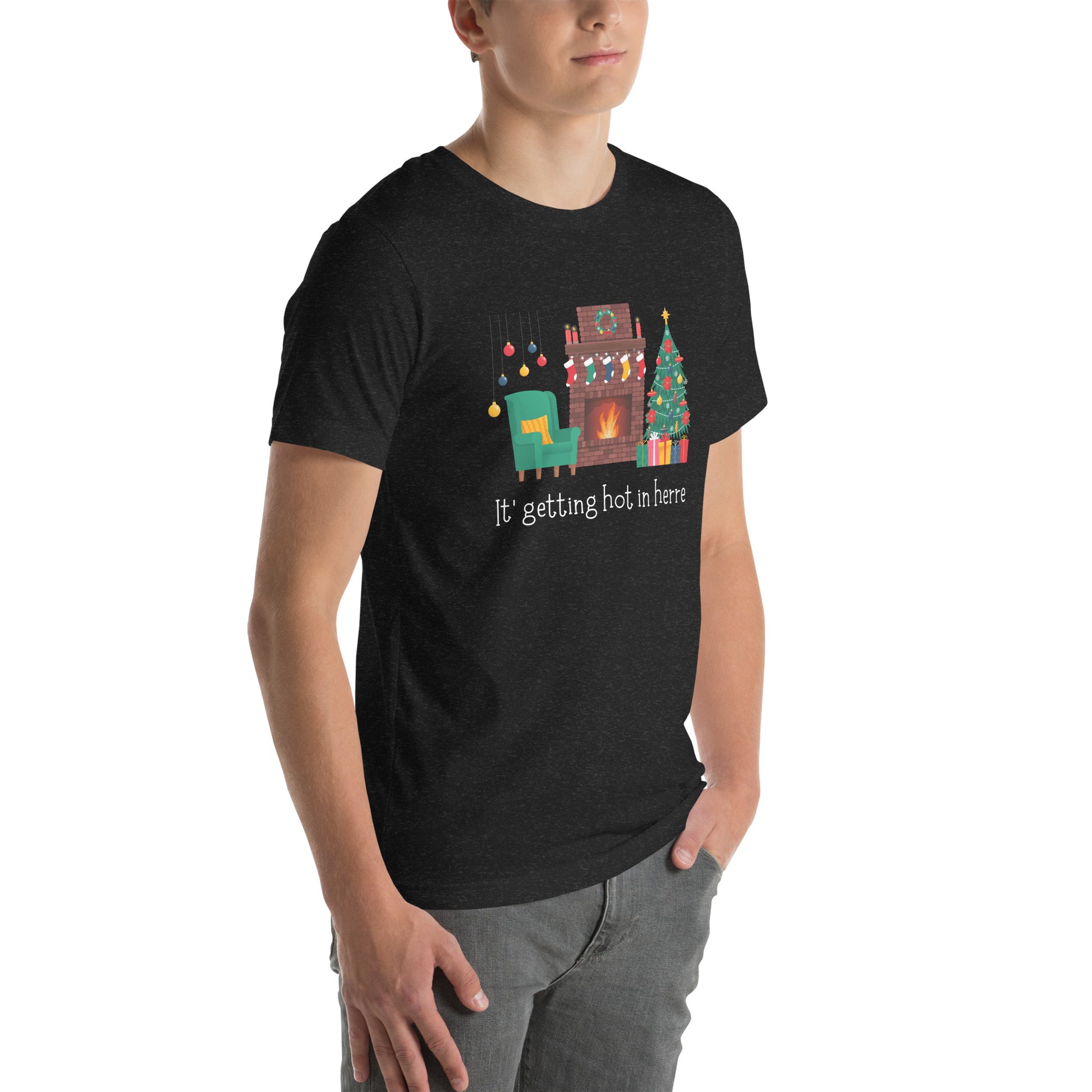 Man wears festive holiday tee shirt that reads "It's getting hot in herre". The design is a cozy Christmas living room with holiday decorations and a roaring fireplace.