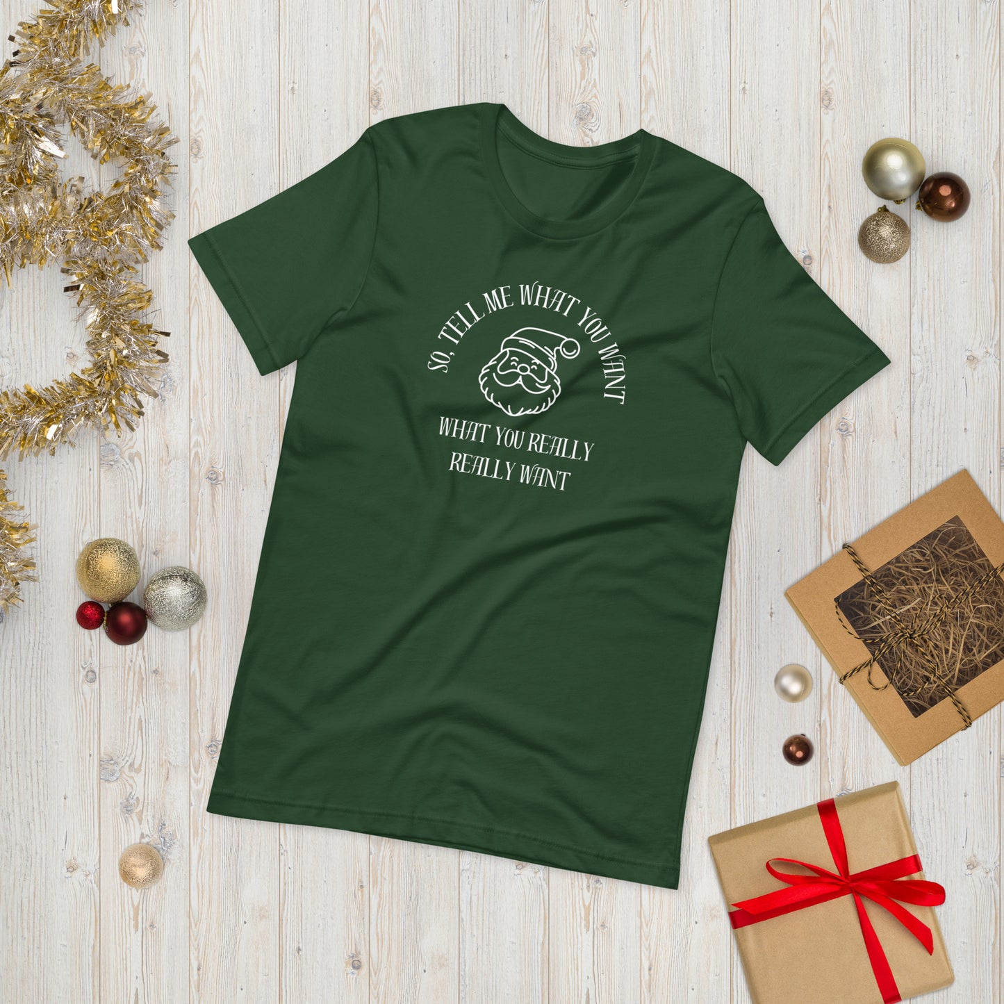 Festive green unisex tee shirt featuring Santa's face and the text "So Tell Me What You Want What You Really Really Want"