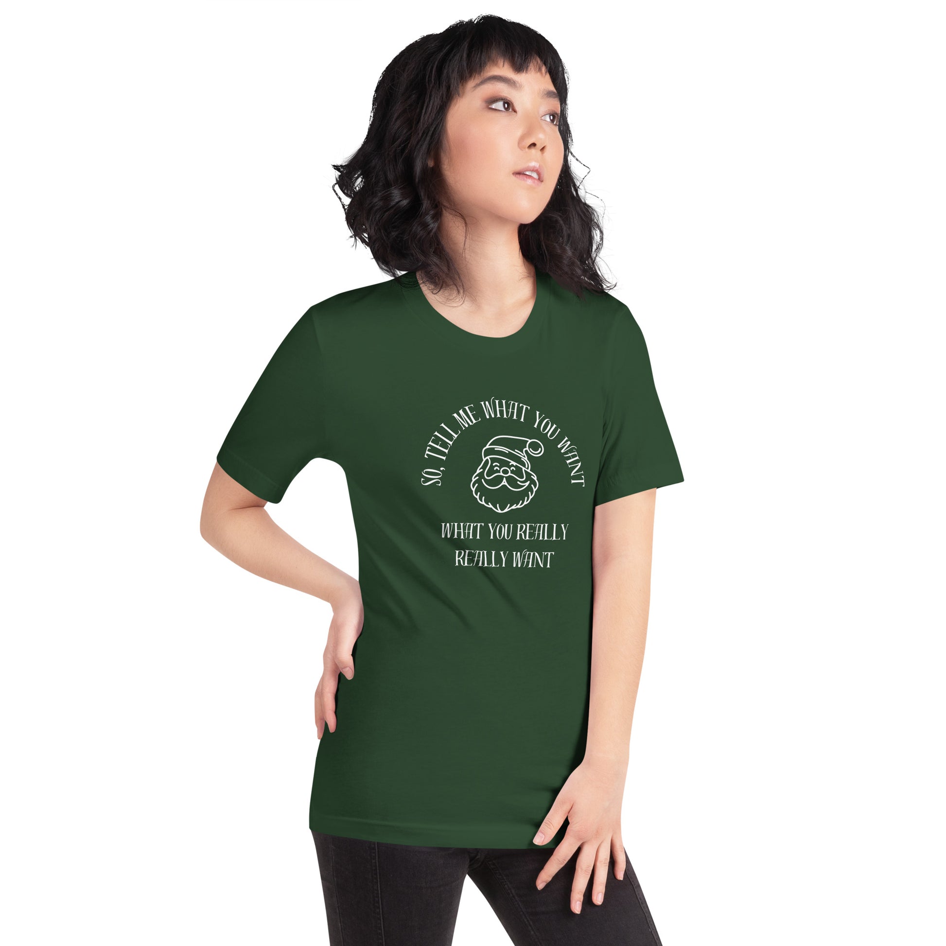 Woman wears festive green unisex tee shirt featuring Santa's face and the text "So Tell Me What You Want What You Really Really Want"