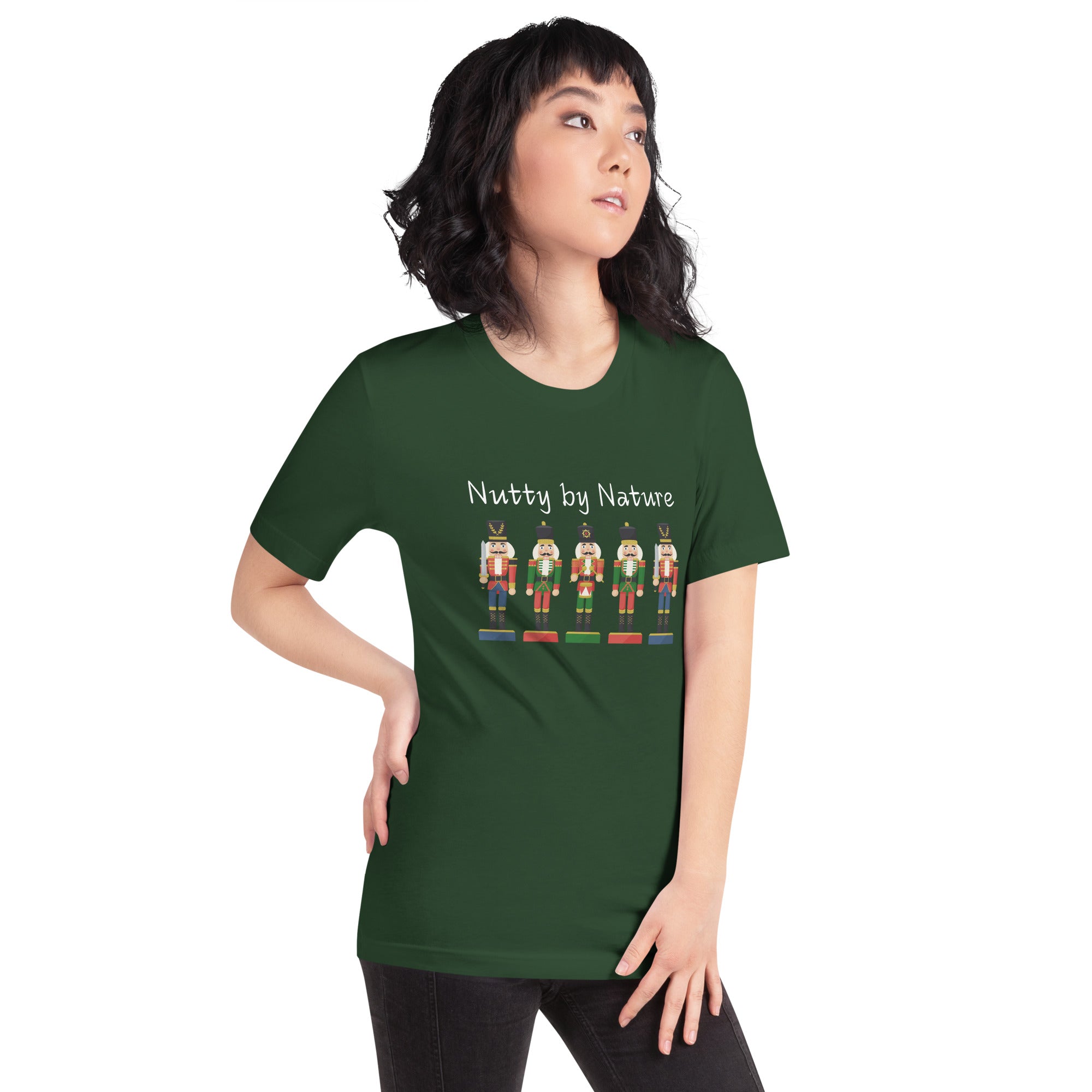 Woman wears a festive and playful holiday shirt featuring five nutcrackers and text that reads "Nutty by Nature"