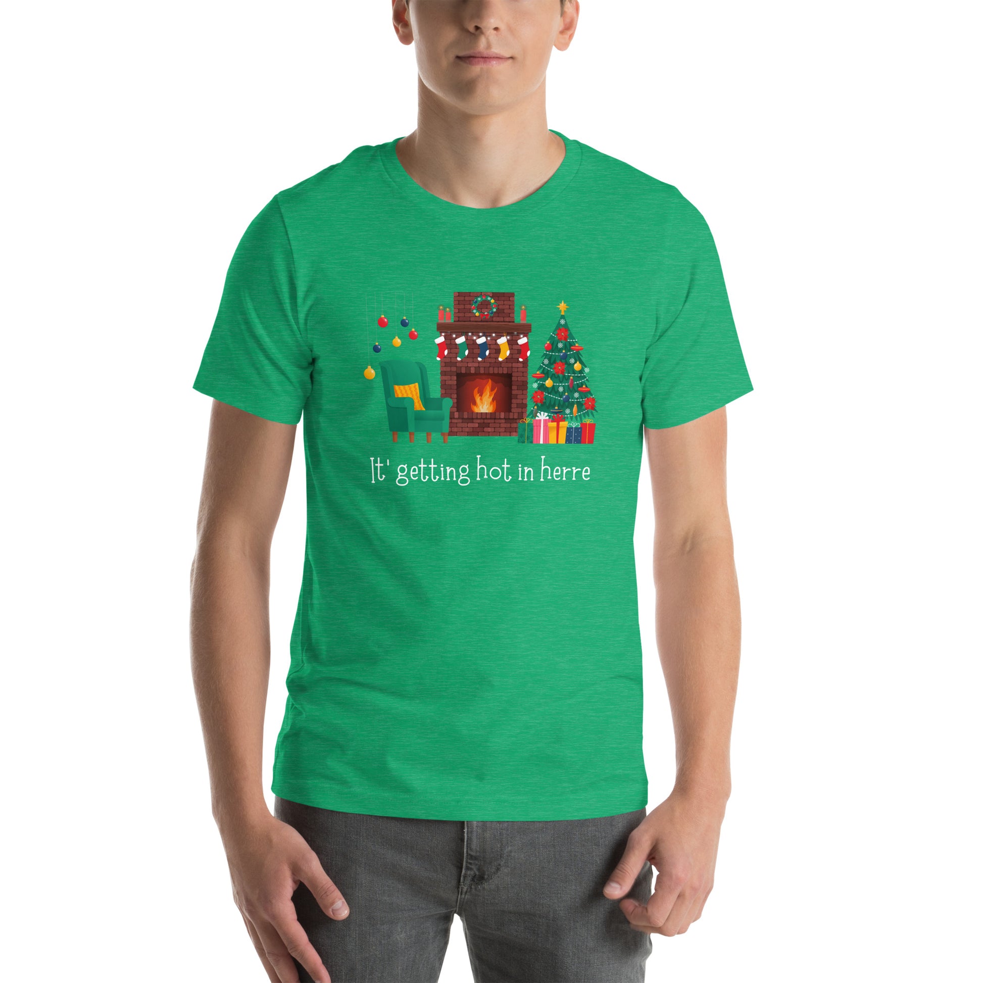 Man wears festive green holiday tee shirt that reads "It's getting hot in herre". The design is a cozy Christmas living room with holiday decorations and a roaring fireplace.