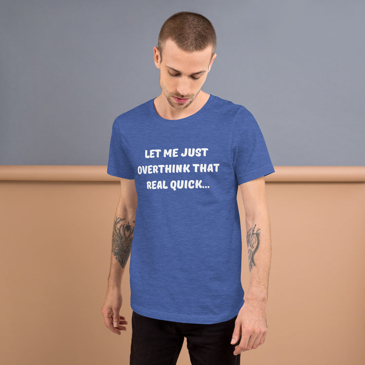 Young man with tattooed arms wears a blue tee shirt that reads "Let me just overthink that real quick..."