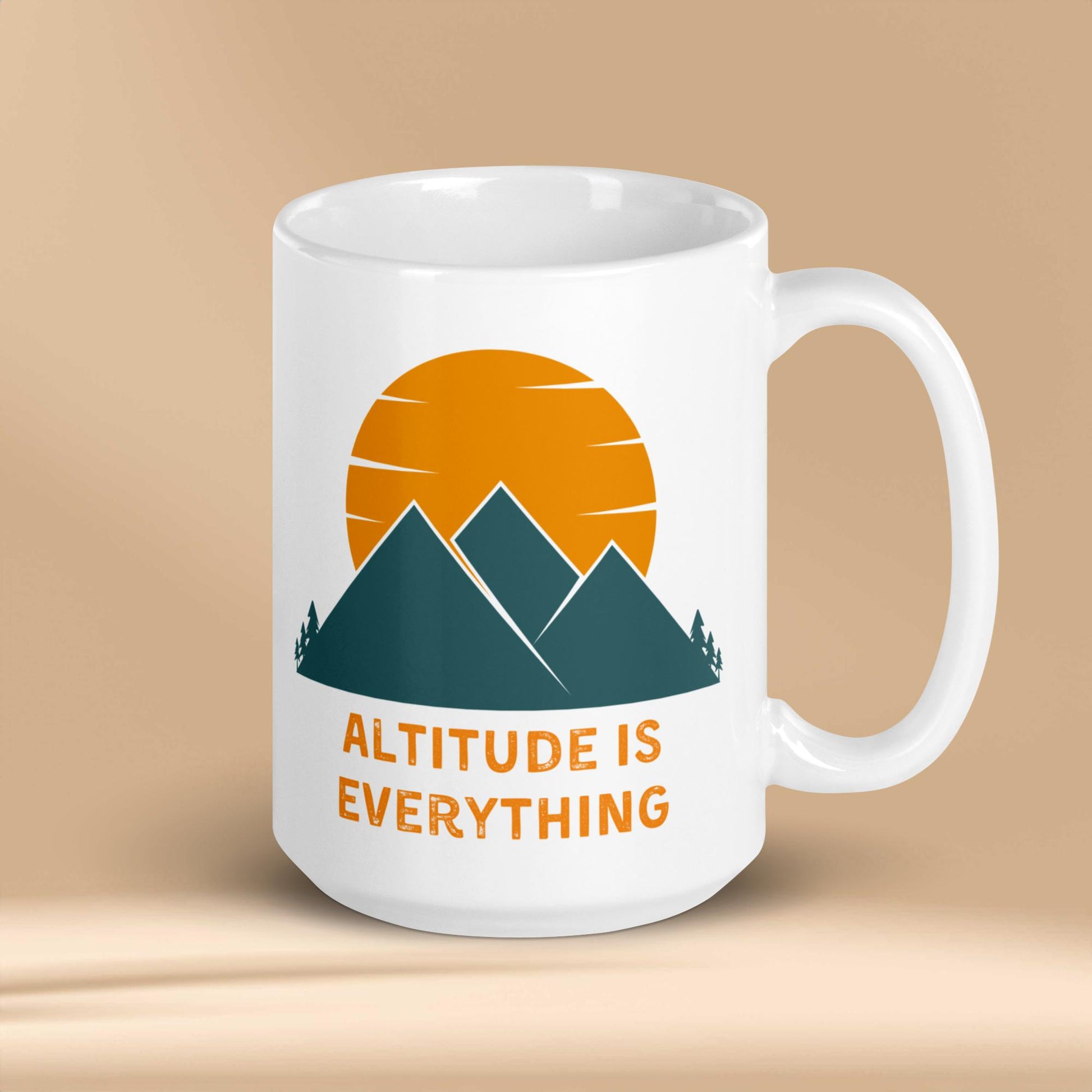 The image shows a white ceramic mug with a graphic design of mountains and a sunset, along with the text "ALTITUDE IS EVERYTHING". 