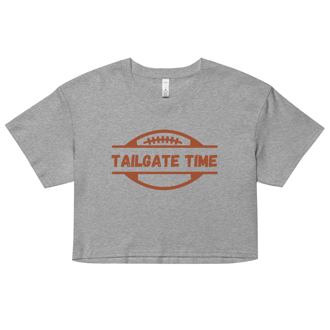 Women's football crop top displays a football and the words "Tailgate Time" in distressed lettering.