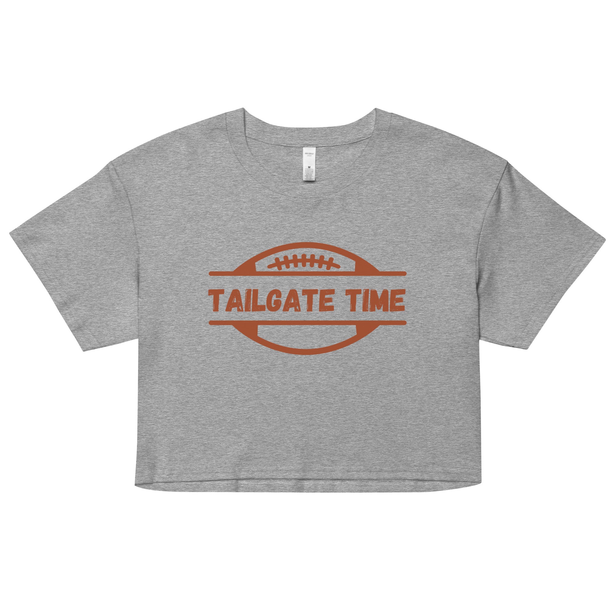 Women's football crop top displays a football and the words "Tailgate Time" in distressed lettering.