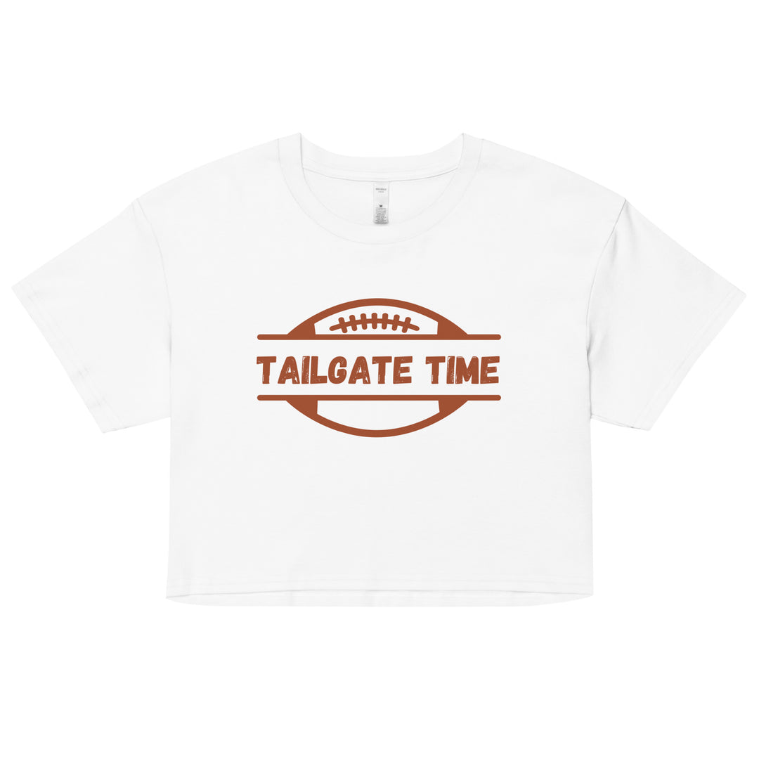 Women's football crop top displays a football and the words "Tailgate Time" in distressed lettering.