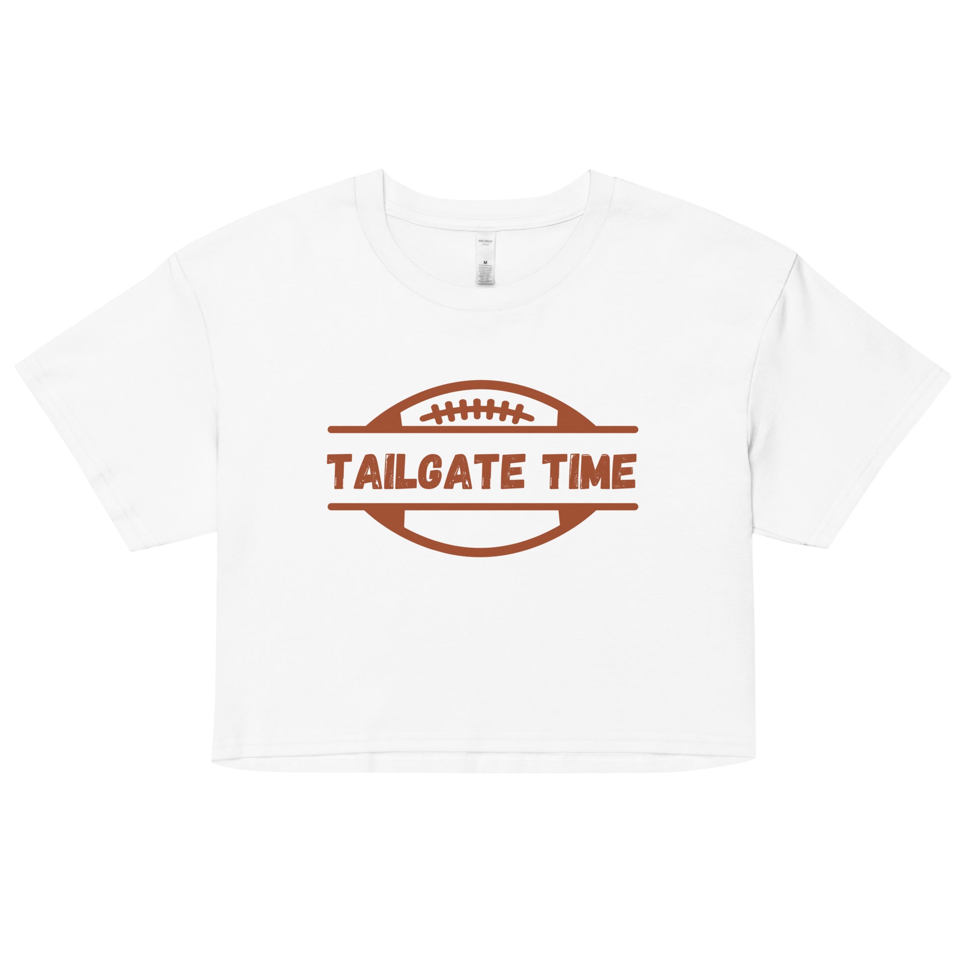 Women's football crop top displays a football and the words "Tailgate Time" in distressed lettering.