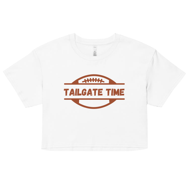 Women's football crop top displays a football and the words "Tailgate Time" in distressed lettering.