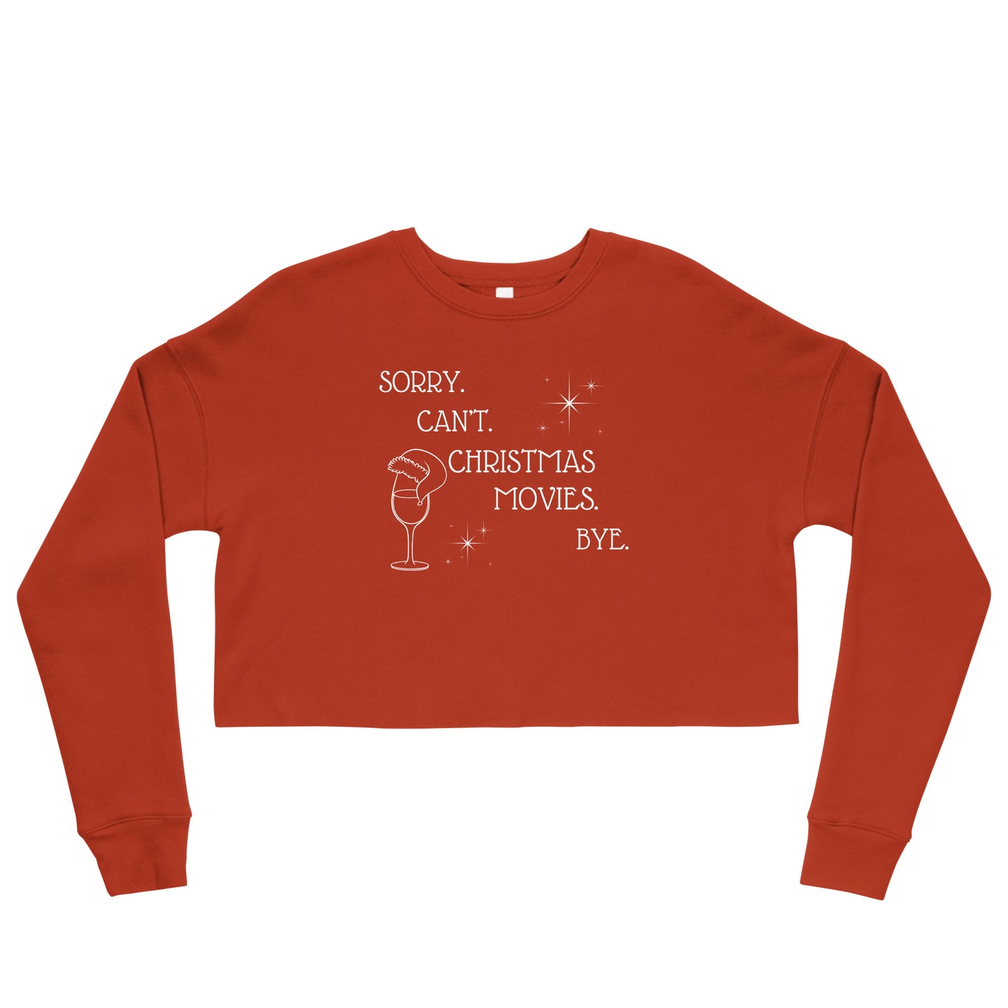 Festive red cropped sweatshirt reads "Sorry. Can't. Christmas Movies. Bye." It's accompanied by a wine glass topped with a Santa hat and star details.