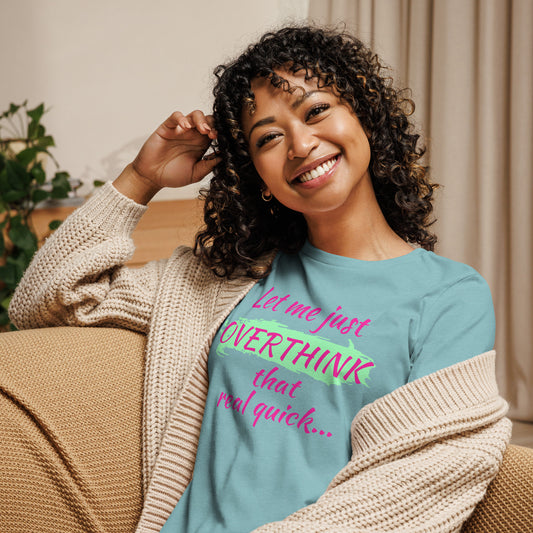 Woman wearing a light blue graphic tee that says "Let me just overthink that real quick" in bold hot pink font  and lime green detail— funny overthinking shirt for women.