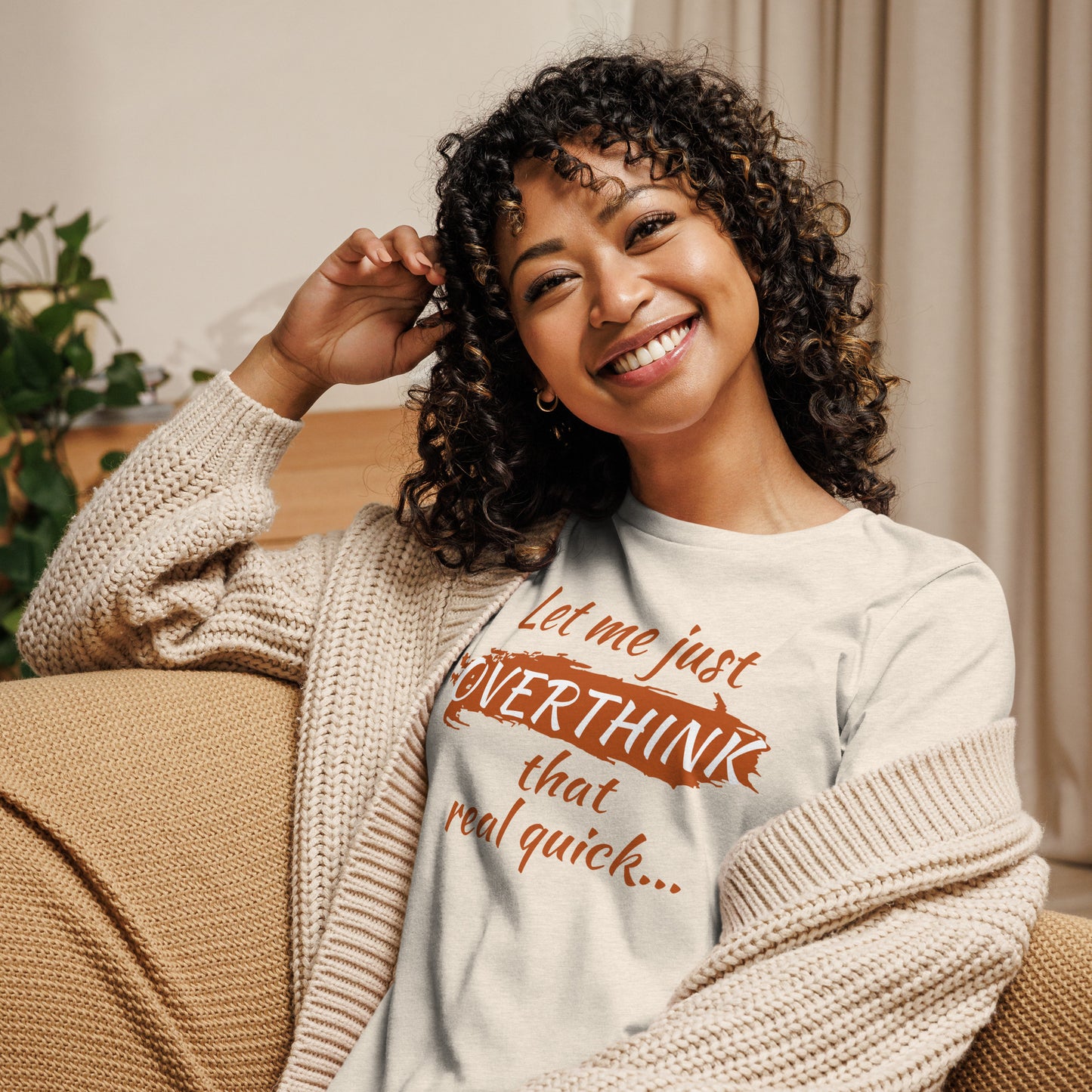 Woman in a cream-colored tee featuring the phrase "Let me just overthink that real quick" in retro burnt orange — perfect gift for overthinkers