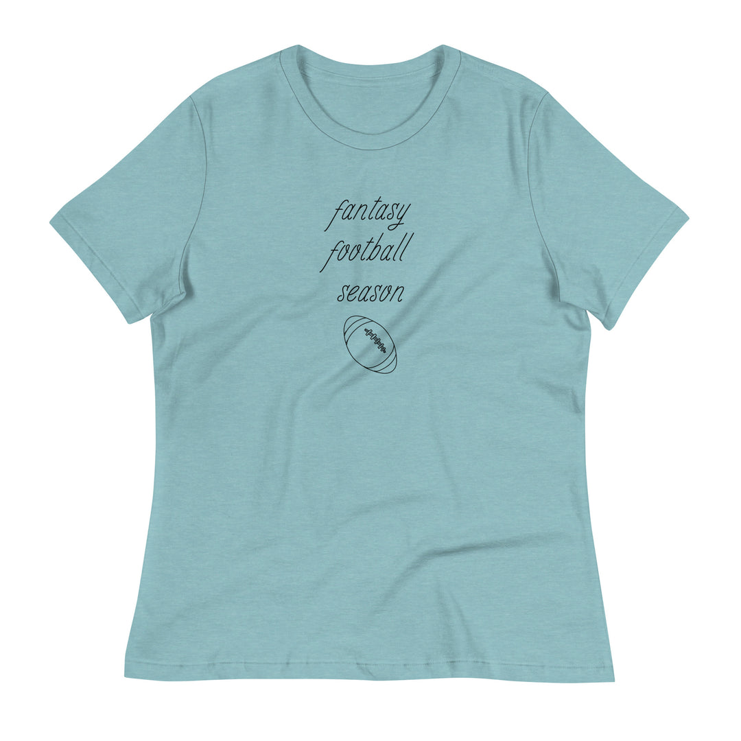 Light blue women's tee shirt that reads "FANTASY FOOTBALL SEASON" along with an image of a football. The font is a thin and flowy cursive that is pretty and feminine.
