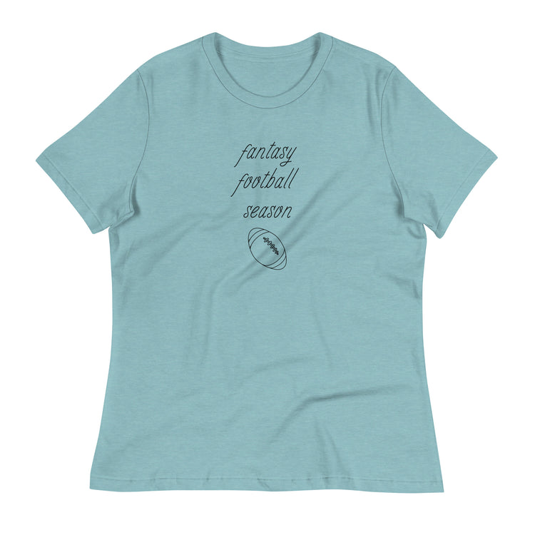 Light blue women's tee shirt that reads "FANTASY FOOTBALL SEASON" along with an image of a football. The font is a thin and flowy cursive that is pretty and feminine.