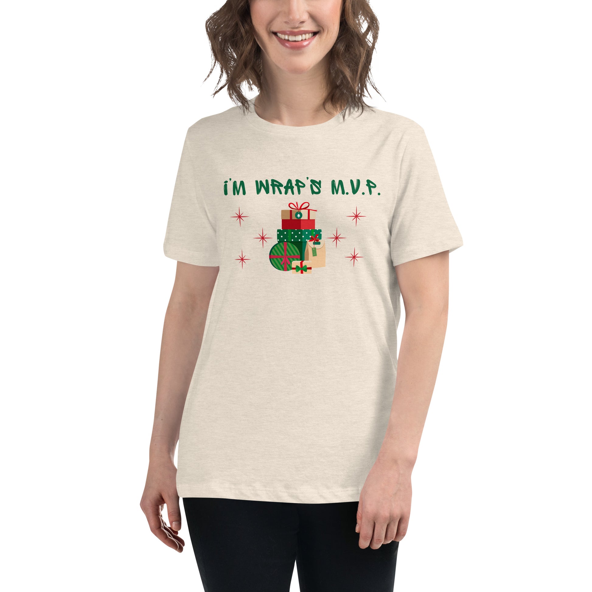 Woman wears a festive holiday tee that reads "I'm wrap's MVP" next to a stack of neatly wrapped holiday gifts and red stars.