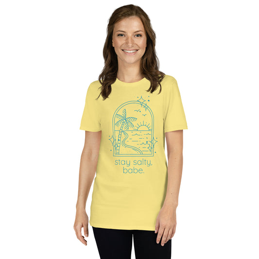 Bright yellow “Stay Salty, Babe” tee with blue graphics on female model with casual summer look