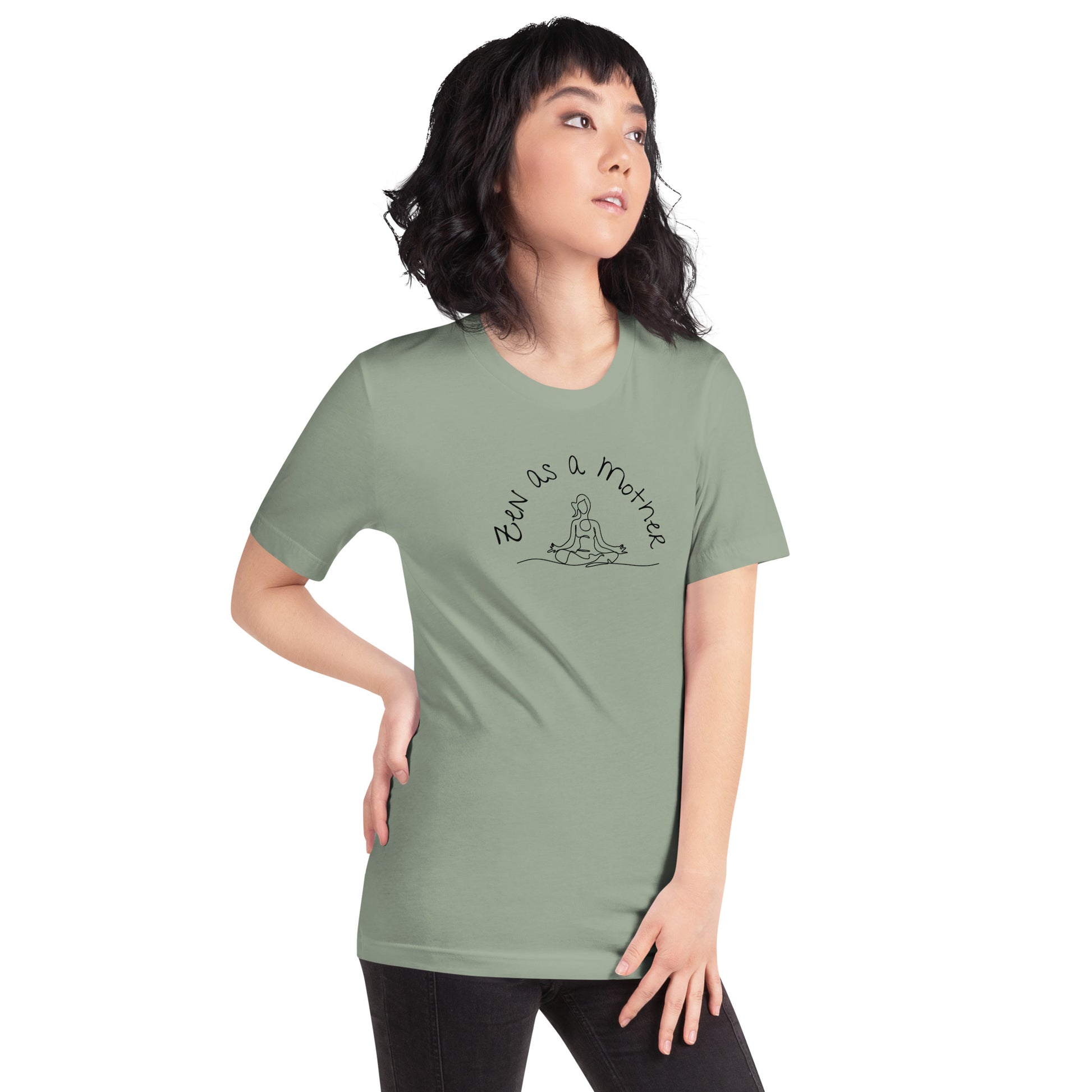 Woman wears sage green zen as a mother tee with black text and yoga line art graphic.